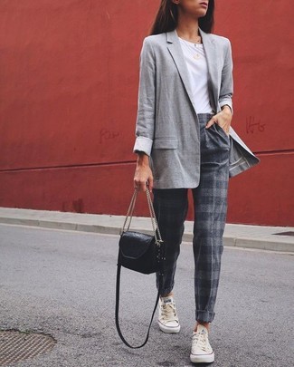 White and Black Low Top Sneakers Outfits For Women: Marrying a grey blazer and grey horizontal striped tapered pants will allow you to exhibit your outfit coordination savvy even on dress-down days. Complement your ensemble with white and black low top sneakers to make a traditional ensemble feel suddenly fresh.