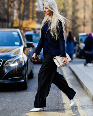 White Leather Ankle Boots Outfits: Demonstrate your styling savvy in this combination of a navy blazer and black wide leg pants. This outfit is completed nicely with white leather ankle boots.