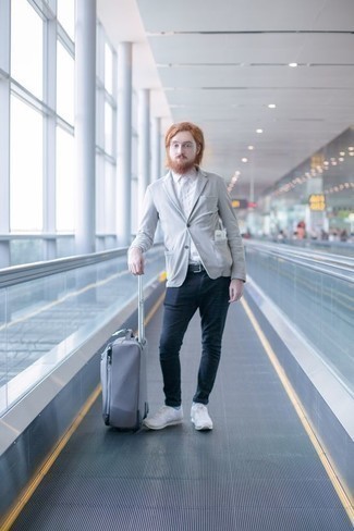 Aquamarine Suitcase Outfits For Men: If you want to look stylish and remain comfortable, reach for a grey blazer and an aquamarine suitcase. Add a pair of white athletic shoes to the mix and you're all done and looking spectacular.