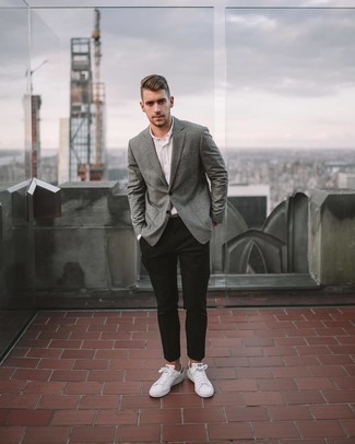 Charcoal Vertical Striped Blazer Outfits For Men: This classic and casual combination of a charcoal vertical striped blazer and black chinos takes on different nuances according to the way you style it out. Complement your look with a pair of white and green leather low top sneakers to instantly up the wow factor of your look.