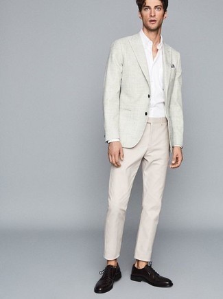 Grey Blazer Warm Weather Outfits For Men: Dress in a grey blazer and beige chinos to be the picture of masculine sophistication. Take this look in a dressier direction by finishing with dark brown leather derby shoes.