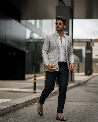 Grey Blazer Outfits For Men: This combination of a grey blazer and navy chinos is a solid bet when you need to look stylish but have no extra time. Introduce charcoal suede tassel loafers to the equation to make the look a bit classier.