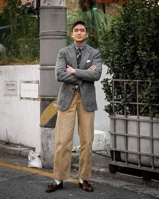 Grey Herringbone Wool Blazer Outfits For Men: Rock a grey herringbone wool blazer with khaki chinos to pull together an interesting and put together ensemble. On the shoe front, go for something on the classier end of the spectrum and complete this ensemble with a pair of dark brown leather tassel loafers.
