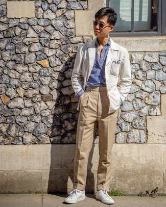 Beige Blazer Outfits For Men: Teaming a beige blazer and khaki chinos is a fail-safe way to infuse your styling routine with some manly sophistication. And if you need to easily tone down this ensemble with one single piece, why not complete this look with white leather low top sneakers?