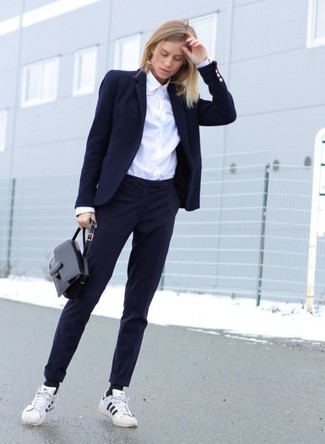 Navy Dress Pants Outfits For Women: This combination of a navy blazer and navy dress pants is super easy to put together in no time flat, helping you look amazing and prepared for anything without spending a ton of time searching through your wardrobe. With shoes, go for something on the relaxed end of the spectrum and complement your look with a pair of white and black horizontal striped low top sneakers.