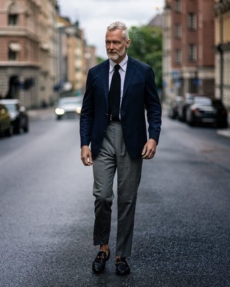 Navy Blazer Dressy Outfits For Men: Definitive proof that a navy blazer and grey dress pants look awesome when combined together in an elegant ensemble for a modern dandy. As for footwear, add a pair of black leather loafers to the equation.