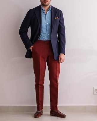 Red Dress Pants Outfits For Men: Consider wearing a navy blazer and red dress pants for a chic and elegant look. Let your expert styling really shine by finishing off this ensemble with a pair of brown leather loafers.