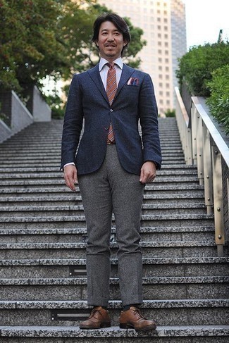 Orange Horizontal Striped Tie Outfits For Men: This is indisputable proof that a navy wool blazer and an orange horizontal striped tie look awesome when you team them up in a sophisticated ensemble for a modern man. Introduce brown leather brogues to this outfit and you're all done and looking amazing.