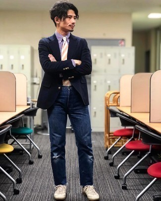 Navy Blazer Casual Outfits For Men: This combo of a navy blazer and navy ripped jeans combines comfort and utility and helps you keep it simple yet contemporary. If you're hesitant about how to finish off, a pair of beige canvas low top sneakers is a goofproof option.