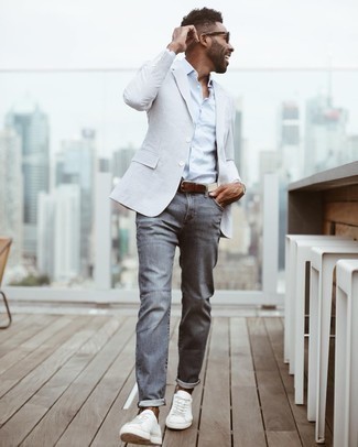 Beige Canvas Belt Outfits For Men: Irrefutable proof that a light blue vertical striped seersucker blazer and a beige canvas belt look amazing when married together in a bold casual look. White canvas low top sneakers are a fail-safe way to give an element of refinement to your outfit.