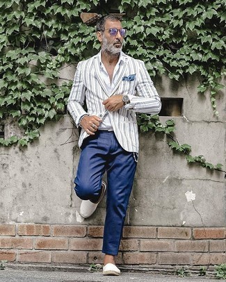 White Vertical Striped Long Sleeve Shirt Outfits For Men: Teaming a white vertical striped long sleeve shirt with navy chinos is an on-point pick for a laid-back and cool ensemble. White canvas espadrilles are a nice idea to round off this getup.