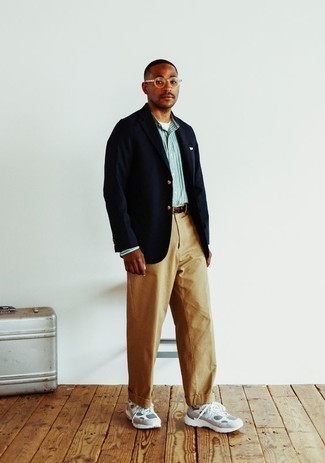 Men's Outfits 2022: When it comes to manly elegance, this pairing of a navy blazer and khaki chinos doesn't disappoint. If you wish to effortlessly play down your ensemble with shoes, why not complement this outfit with a pair of white athletic shoes?