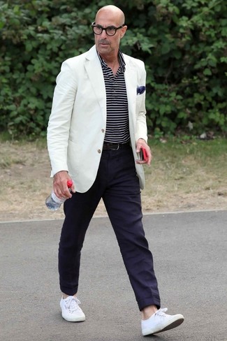 Stanley Tucci wearing White Blazer, Navy and White Horizontal Striped Polo, Navy Chinos, White Canvas Low Top Sneakers