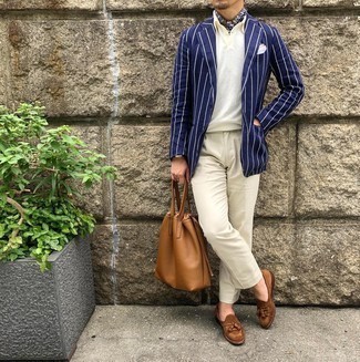 Tan Leather Tote Bag Outfits For Men: A navy and white vertical striped blazer and a tan leather tote bag are wonderful menswear essentials that will integrate well within your off-duty wardrobe. Kick up the wow factor of your ensemble by rounding off with a pair of brown suede tassel loafers.