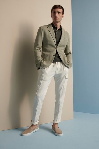 Olive Blazer Outfits For Men: Such items as an olive blazer and white cargo pants are an easy way to introduce subtle dapperness into your current wardrobe. If you're hesitant about how to finish off, a pair of tan suede slip-on sneakers is a safe option.