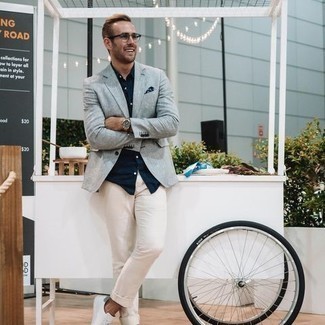 Light Blue Blazer Outfits For Men: For relaxed refinement with a manly spin, you can easily dress in a light blue blazer and beige chinos. A trendy pair of white canvas low top sneakers is the most effective way to give a dose of stylish nonchalance to this ensemble.