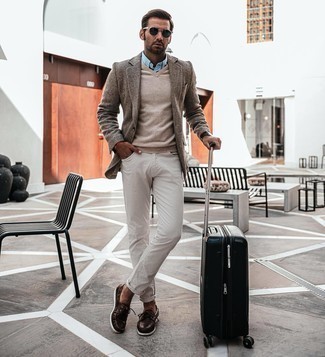 Black Suitcase Outfits For Men: If you appreciate function above all, this relaxed combination of a grey herringbone wool blazer and a black suitcase is your go-to. Rounding off with a pair of dark brown leather boat shoes is a surefire way to breathe a touch of elegance into this getup.