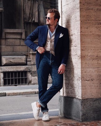 White and Black Vertical Striped Dress Shirt Outfits For Men: Go for a pared down but sharp ensemble in a white and black vertical striped dress shirt and navy jeans. Send your ensemble in a sportier direction by sporting a pair of white leather low top sneakers.