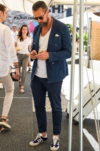 Blue Denim Blazer Outfits For Men: Such staples as a blue denim blazer and navy chinos are the ideal way to introduce a dash of rugged sophistication into your daily off-duty wardrobe. Want to play it down on the shoe front? Throw a pair of navy and white canvas low top sneakers into the mix for the day.