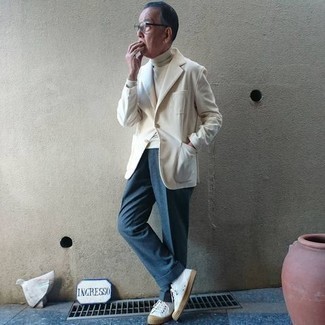White Turtleneck Outfits For Men After 60: This combination of a white turtleneck and blue dress pants is a tested option when you need to look like a true connoisseur of modern men's fashion. Let your styling prowess really shine by completing this look with a pair of white canvas low top sneakers. Like this idea for your styling routine as an older gentleman?