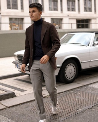 Dark Brown Blazer Outfits For Men: You're looking at the irrefutable proof that a dark brown blazer and grey dress pants look amazing when married together in a polished ensemble for a modern guy. Take a more laid-back approach with footwear and add a pair of white and red leather low top sneakers to the equation.