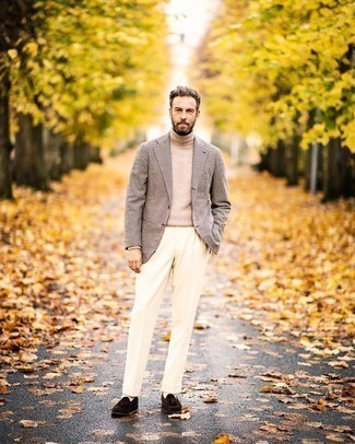 Beige Wool Turtleneck Outfits For Men: Putting together a beige wool turtleneck and white dress pants will hallmark your outfit coordination skills. Let your sartorial prowess really shine by rounding off your outfit with a pair of dark brown suede tassel loafers.