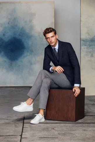 Navy Polka Dot Tie Outfits For Men: Irrefutable proof that a navy blazer and a navy polka dot tie look amazing when paired together in a polished outfit for a modern man. To infuse a dressed-down touch into this outfit, choose a pair of white leather low top sneakers.
