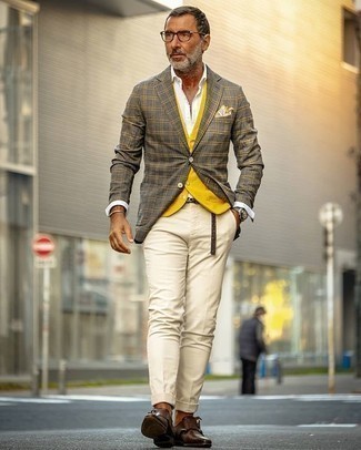 Mustard Waistcoat Outfits: Pairing a mustard waistcoat with beige chinos is an awesome idea for a stylish and sophisticated look. Introduce a pair of dark brown leather double monks to this look and the whole look will come together.