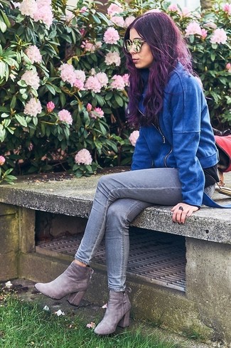 This is solid proof that a blue suede biker jacket and grey skinny jeans are awesome when married together in a casual look. Add grey suede ankle boots to the mix for an extra dose of style.