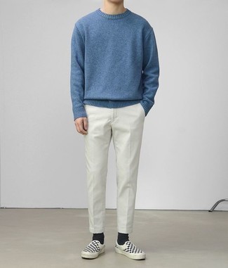 Black Canvas Slip-on Sneakers Outfits For Men: A blue crew-neck sweater and white chinos are absolute menswear must-haves if you're crafting a casual wardrobe that matches up to the highest fashion standards. For maximum fashion points, add a pair of black canvas slip-on sneakers to the mix.
