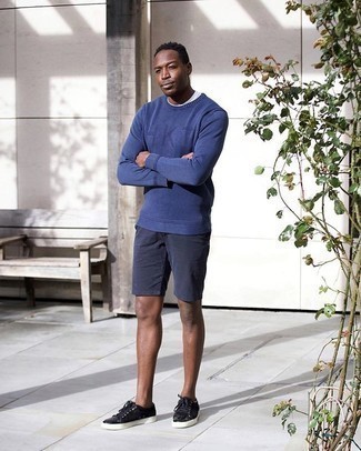 Black Suede Low Top Sneakers Outfits For Men: A blue crew-neck sweater and navy shorts are the kind of a winning off-duty ensemble that you so awfully need when you have zero time. Opt for black suede low top sneakers and the whole look will come together perfectly.