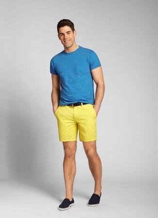 Yellow Shorts Outfits For Men: Showcase your skills in menswear styling by opting for this laid-back pairing of a blue crew-neck t-shirt and yellow shorts. Why not take a dressier approach with shoes and complement this outfit with navy canvas slip-on sneakers?