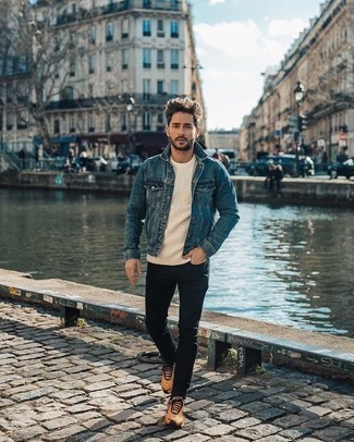 Blue Denim Jacket Outfits For Men: This laid-back pairing of a blue denim jacket and black jeans is a winning option when you need to look dapper in a flash. To give your outfit a more casual vibe, introduce a pair of tan athletic shoes to your ensemble.