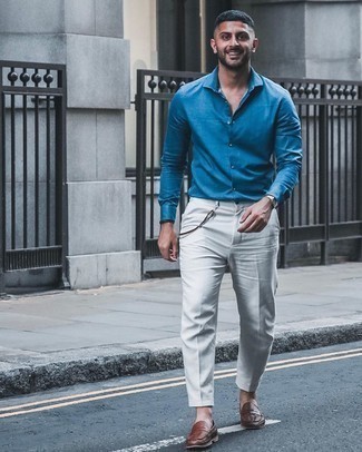 Gold Watch Outfits For Men: Team a blue dress shirt with a gold watch for a laid-back take on casual city combinations. Want to go all out on the shoe front? Introduce brown woven leather loafers to this look.