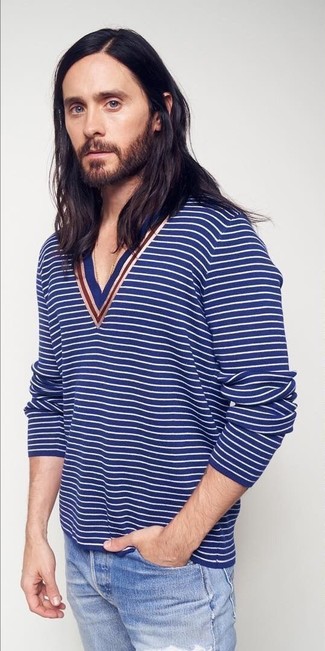 Rushed mornings call for a simple yet laid-back and cool ensemble, such as a blue horizontal striped v-neck sweater and light blue ripped jeans.