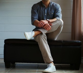 Blue Chambray Long Sleeve Shirt with White Low Top Sneakers Outfits For Men: Look dapper without trying too hard by opting for a blue chambray long sleeve shirt and beige chinos. Tone down the formality of this look by finishing with a pair of white low top sneakers.
