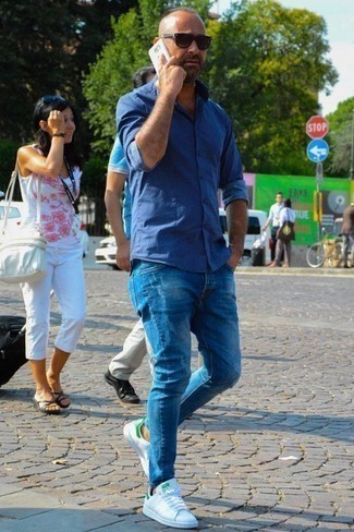 Men's Blue Long Sleeve Shirt, Blue Jeans, White and Green Leather Low Top Sneakers, Black Sunglasses