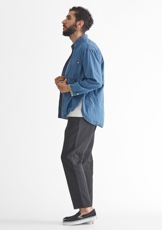 Black Canvas Slip-on Sneakers Outfits For Men: A blue chambray long sleeve shirt and charcoal chinos are both versatile menswear must-haves that will integrate nicely within your off-duty styling arsenal. If you're wondering how to round off, introduce black canvas slip-on sneakers to the equation.