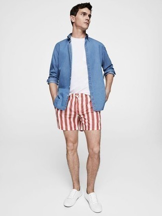 White and Red Vertical Striped Sports Shorts Outfits For Men: If you prefer a more casual approach to style, why not team a blue chambray long sleeve shirt with white and red vertical striped sports shorts? Avoid looking too casual by rounding off with white canvas low top sneakers.