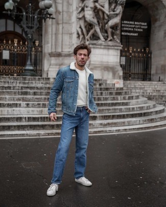 Blue Denim Shearling Jacket Outfits For Men: For a casually stylish look, consider pairing a blue denim shearling jacket with blue jeans — these pieces go beautifully together. To inject a fun touch into this ensemble, introduce white canvas low top sneakers to your look.