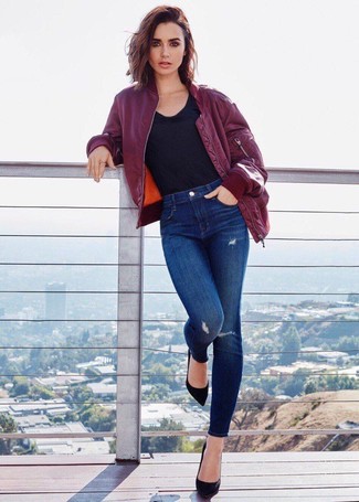 Lily Collins wearing Black Suede Pumps, Blue Ripped Skinny Jeans, Black Crew-neck T-shirt, Burgundy Bomber Jacket