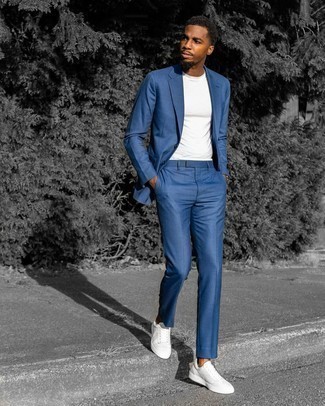 Navy Suit with White and Blue Canvas Low Top Sneakers Outfits In Their 20s: A navy suit and a white crew-neck t-shirt are the kind of a tested outfit that you so awfully need when you have no extra time. If you don't want to go all out formal, finish off with a pair of white and blue canvas low top sneakers. Sport this pairing to create a more mature look as a younger man.