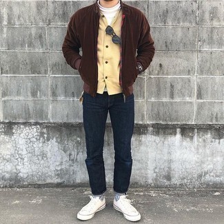 Men's Outfits 2021: For seriously stylish menswear style without the need to sacrifice on functionality, we like this combination of a dark brown bomber jacket and navy jeans. If you're puzzled as to how to round off, add white canvas low top sneakers.