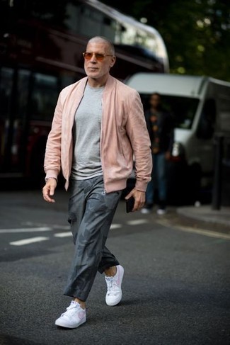 Grey Print Chinos Outfits: A pink bomber jacket and grey print chinos are both versatile menswear staples that will integrate wonderfully within your off-duty rotation. When it comes to shoes, complement your ensemble with a pair of white leather low top sneakers.