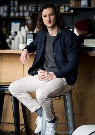 Navy Bomber Jacket Outfits For Men: A navy bomber jacket and beige chinos will allow you to demonstrate your sartorial self. Rounding off with white canvas low top sneakers is the simplest way to infuse a mellow touch into this outfit.