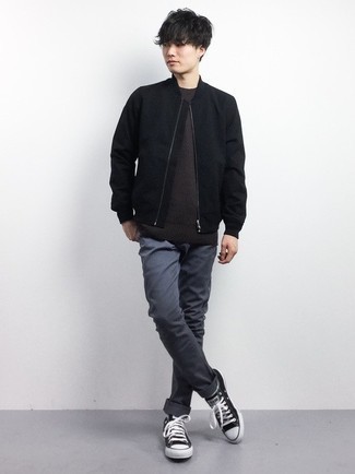 Black Bomber Jacket Outfits For Men: For a foolproof laid-back option, you can rely on this pairing of a black bomber jacket and charcoal chinos. Finishing with black and white canvas low top sneakers is an effective way to inject a more laid-back twist into this ensemble.