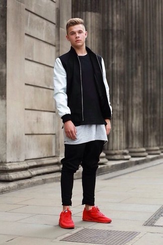Go for a simple but at the same time casually cool option by marrying a black and white bomber jacket and black jeans. A pair of red leather low top sneakers looks awesome completing your ensemble.