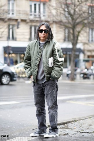 Olive Bomber Jacket Outfits For Men: For a city casual look, Wear an olive bomber jacket and grey ripped jeans. Feeling experimental? Jazz things up by sporting a pair of grey canvas low top sneakers.