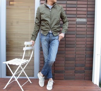 Light Blue Canvas Low Top Sneakers Outfits For Men: An olive bomber jacket and blue jeans are the kind of a winning casual combo that you need when you have zero time to dress up. Introduce a pair of light blue canvas low top sneakers to the mix and the whole look will come together perfectly.