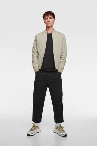 Beige Athletic Shoes Outfits For Men: This pairing of a beige bomber jacket and black cargo pants is the perfect foundation for a cool and casual outfit. Infuse some much need fun and experimentation into this look with the help of a pair of beige athletic shoes.
